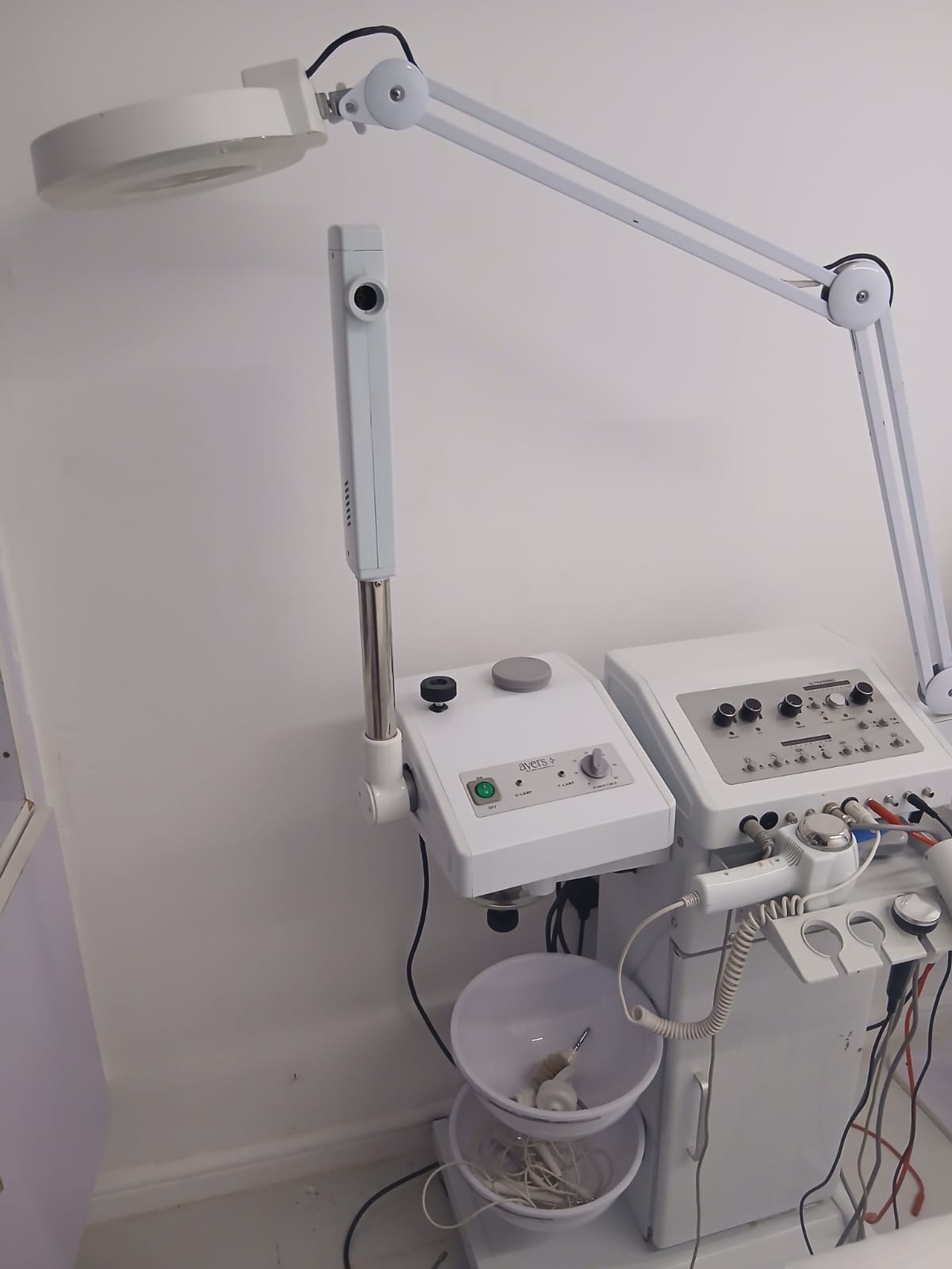 Professional facial equipment — magnifying lamp and skincare machine
