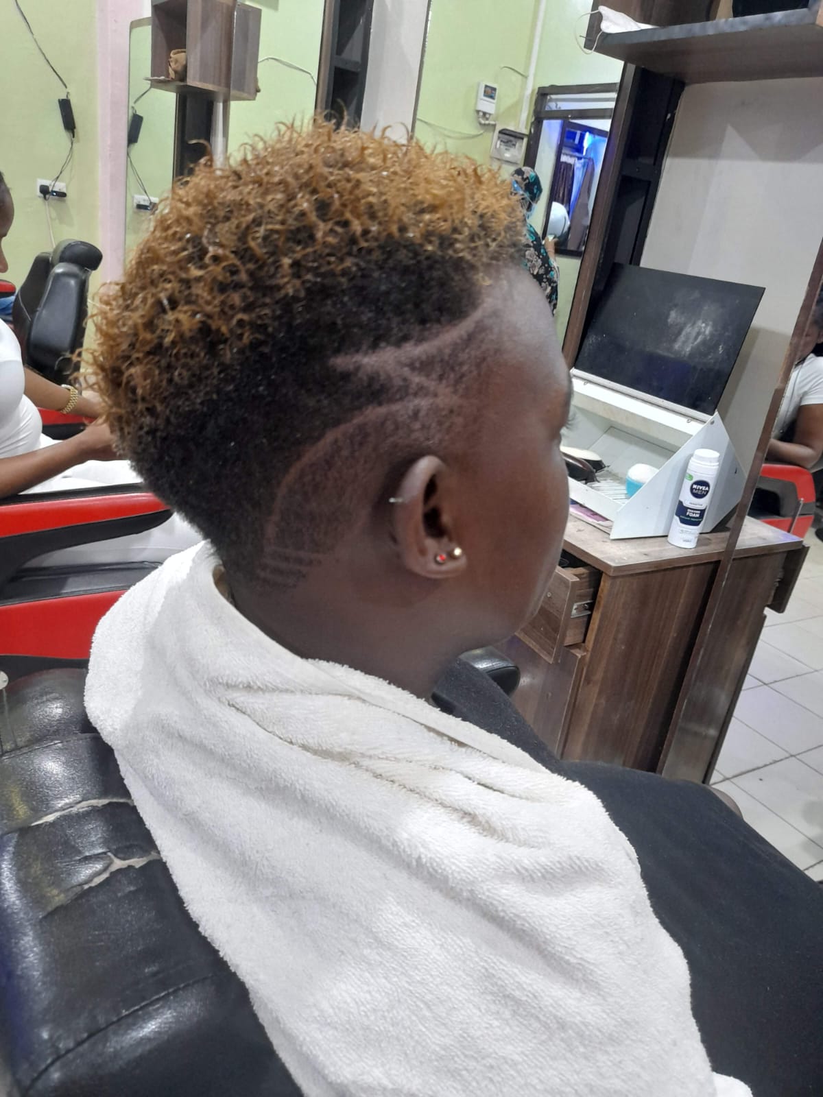 Blonde curls with sharp fade — barbering at Sarma